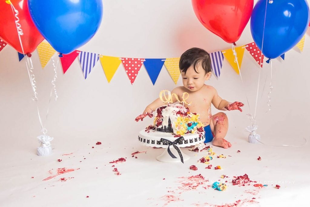 cake all over the floor and baby boy during a cake smash in nj photo studio, messy cake smash