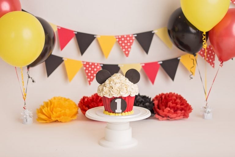props and setup for a mickey mouse cake smash photo session