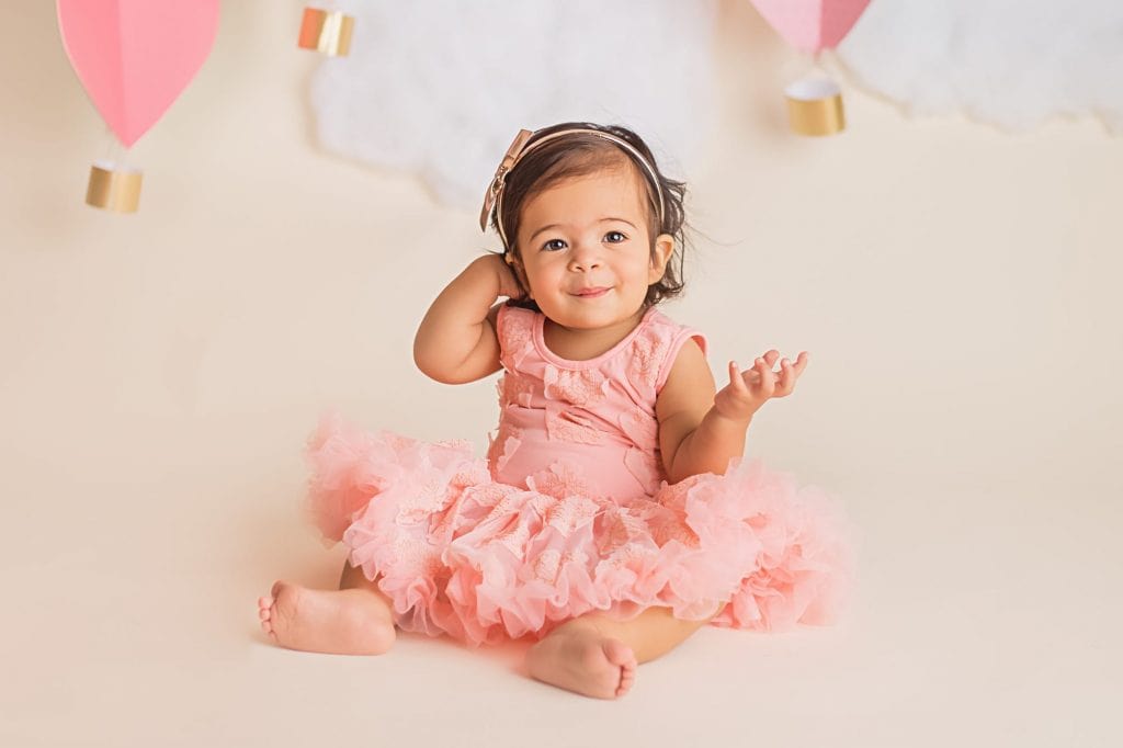 baby girl in a tutu dress for a first year baby photography portrait session