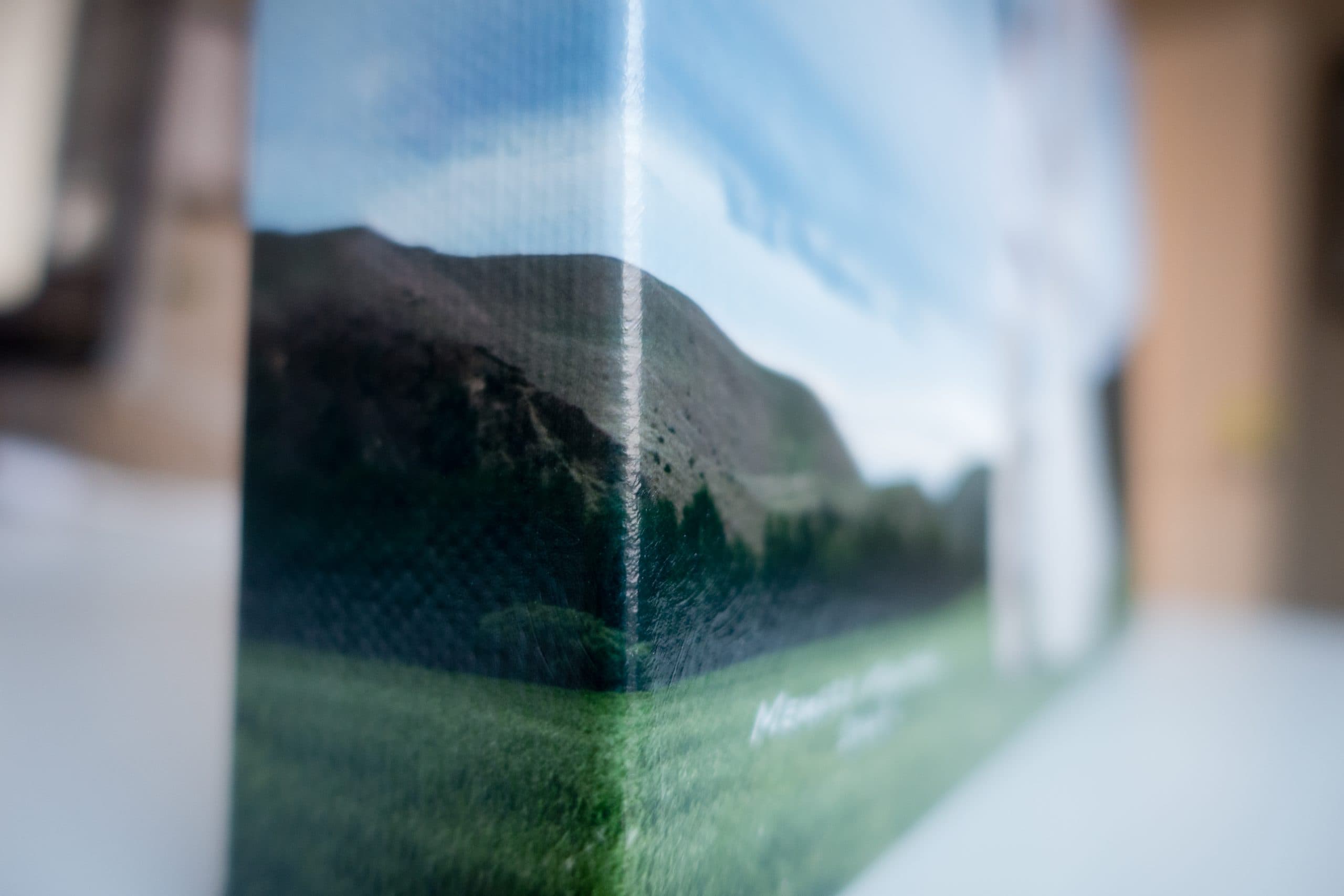 Close-up of a canvas wrap corner, highlighting the texture and detail of the canvas material; partial view of the portrait.