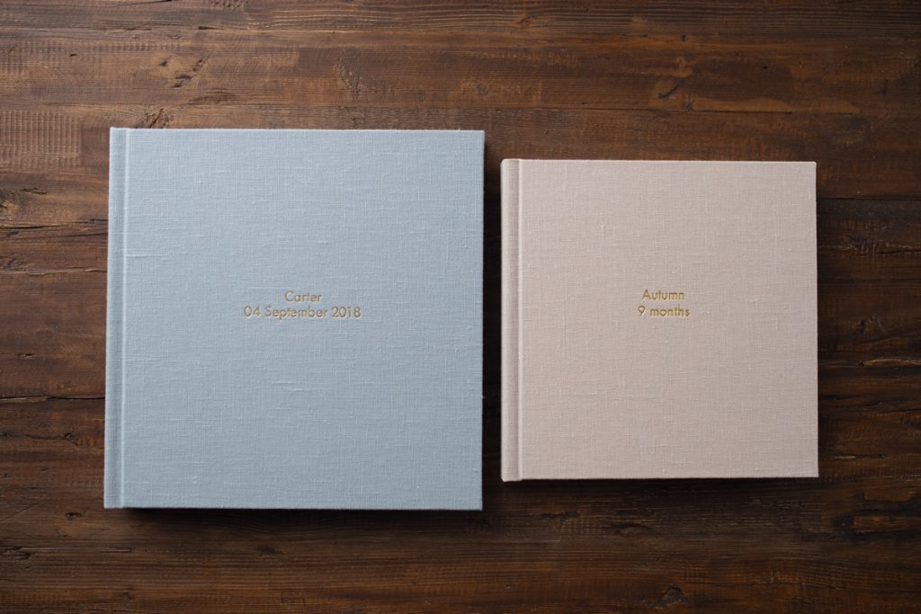 Two albums side by side, one larger than the other. To demonstrate different sizes in the parent album versus duplicate album.
