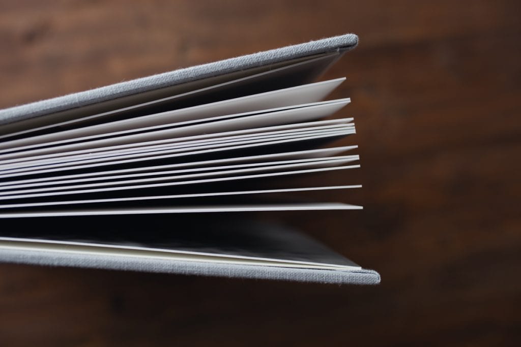 detail shot of thick album pages fanned open, shot from above.