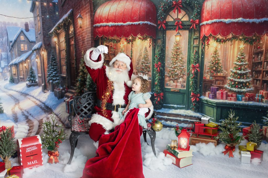 Santa sits on bench in a snowy scene with a preschool-aged girl, pulling magic dust from his toy bag as they gaze up in awe.